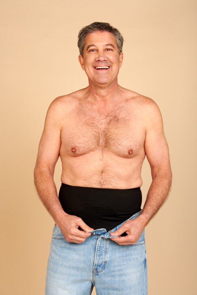 black colostomy bag cover belt for men at work man wearing a black ostomy belt over jeans as a colostomy bag cover