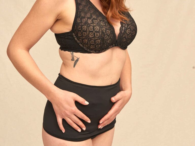 Black SIIL ostomy wrap holding the pouch flat against the body